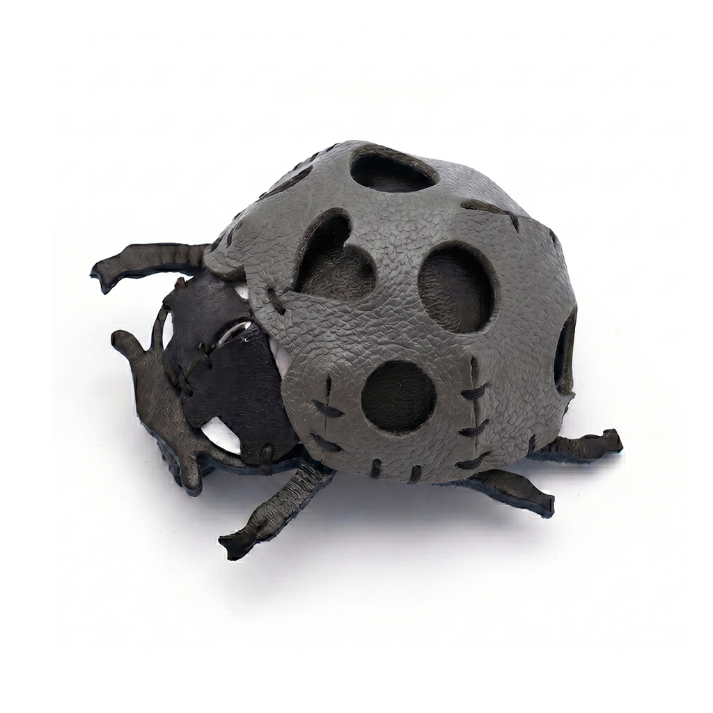 The Grey colourway — a ladybird model in pebbled leather, hand-stitched, with round and heart-shaped cutouts.