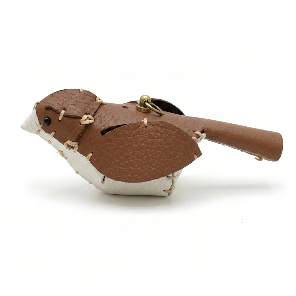 The Brown and White colourway — a leather bird with a brown back and white breast.