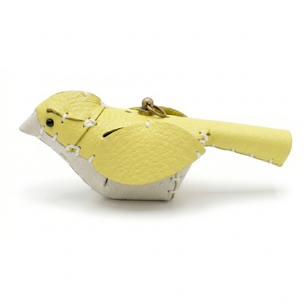 The Yellow and White colourway — a leather bird with a yellow back and white breast.