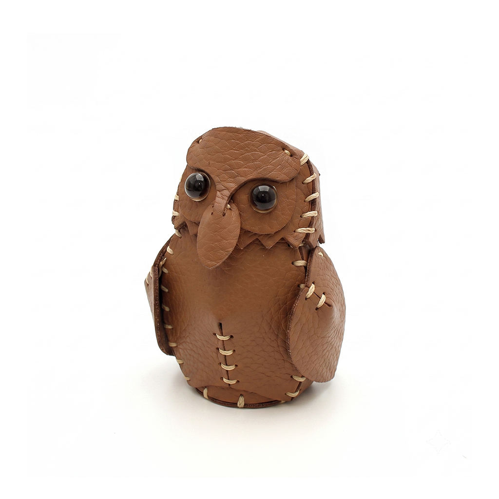 The Brown colourway — a single hand-stitched leather owlet, front view.
